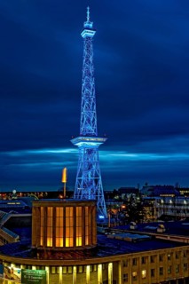 Blue-lit Berlin radio tower, steel half-timbered building by architect Heinrich Straumer, Langer