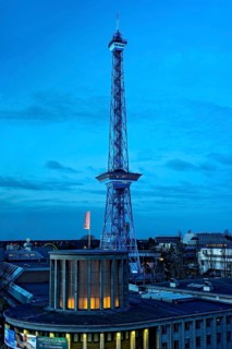Blue-lit Berlin radio tower, steel half-timbered building by architect Heinrich Straumer, Langer