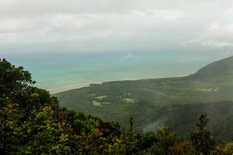 Distant tropical view from Mount Sorrow across valley and bay to where the Great Barrier Reef meets