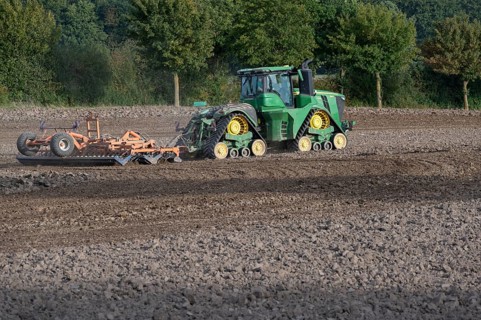 Crawler tractors harrow the field, Othenstorf, Mecklenburg-Western Pomerania, Germany