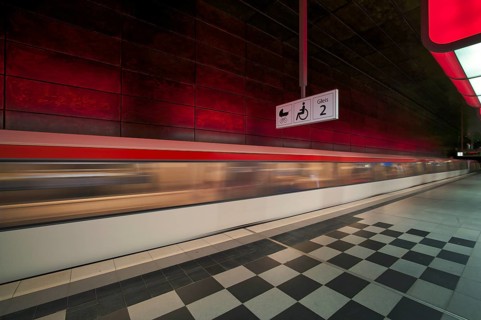 HafenCity University underground station, illuminated in color, red, underground train, movement
