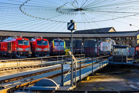 Turntable and overhead line spider, behind it modern locomotives of the Austrian Federal Railways,