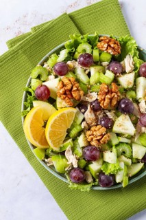 Fresh Waldorf salad, celery stalk with chicken, apple and walnuts, grapes, herbs, homemade, without