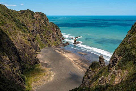 Landscape in New Zealand with sea and sandy beach. View of Mercer Bay. Mercer Bay Loop Walk hiking