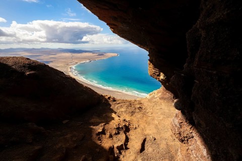 Cueva de las Cabras cave, view from the Risco de Famara cliffs on Famara beach, Playa de Famara