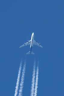 Boeing 747 jumbo jet cargo aircraft of Atlas air airlines flying in a blue sky with contrails or