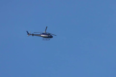 Airbus H125 helicopter flying in a blue sky, England, United Kingdom