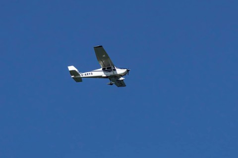 Cessna 172C Skyhawk aircraft flying in a blue sky, England, United Kingdom
