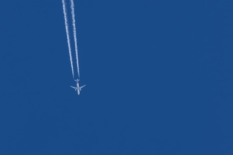 Airbus jet passenger aircraft of Eurowings airlines flying in a blue sky with contrails or vapour