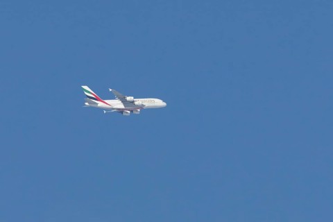Airbus A380 jet passenger aircraft of Emirates airlines flying in a blue sky, England, United