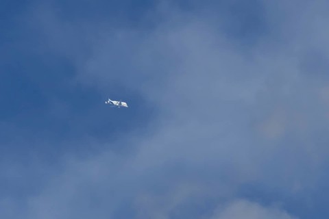 Airbus A330-743L Beluga XL cargo jet aircraft flying in a blue sky with white clouds, England,