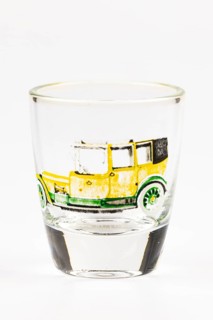 Shot glass with historic car motif, mainly in yellow