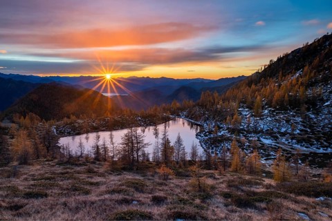 Laghetto dei Saléi mountain lake with autumnal larches (Larix) at sunrise, Onsernone Valley, Canton