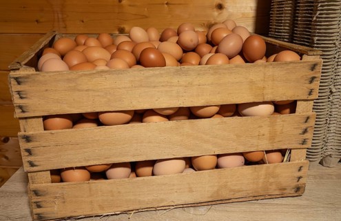 Natural fresh eggs in wooden boxes prepared by the farm for regional sale
