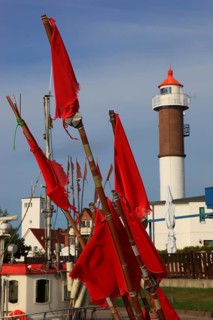 Timmendorf lighthouse on the island of Poel on the Baltic Sea, rigging and flags from a boat in the