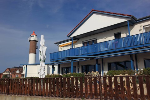 Timmendorf lighthouse on the island of Poel on the Baltic Sea, building in the foreground,