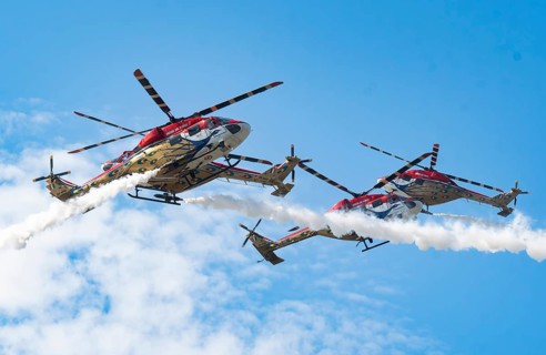Indian Air Force (IAF) ALH Mk1 Sarang helicopters soar through the sky during an air show as part