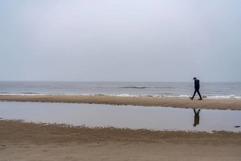 East beach of the East Frisian island of Spiekeroog, beach walk, man alone on the beach, at low