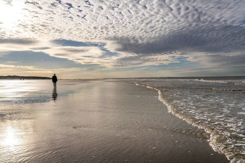 Walkers on the Wadden Sea near the East Frisian island of Spiekeroog, west of the North Sea island,