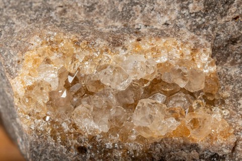 Translucent crystals shimmer in granite rocks. The discovery takes place in summer in a quiet,