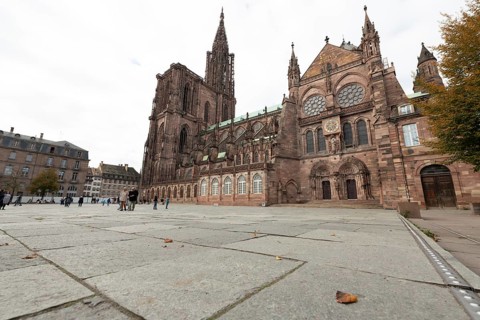 Strasbourg Cathedral impresses with its Gothic architecture. Passers-by moves around the square