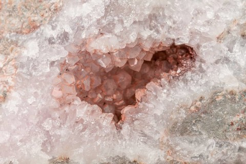 A sparkling quartz geode reveals sparkling crystals inside. The light plays with the facets of