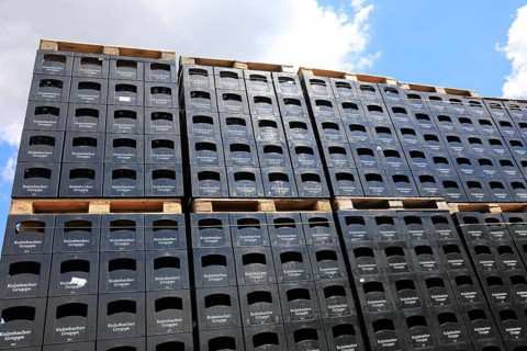 Stacked black beer crates from the Kulmbacher Group, a beverage manufacturer that includes