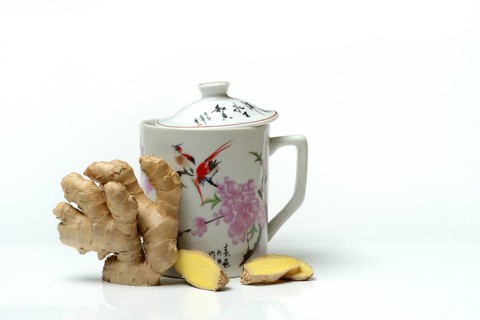 Ginger root with cup, ginger tea