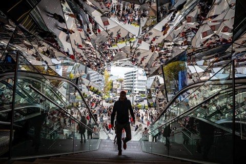 Young man on a stairway, entrance to a shopping center with many mirrors, Tokyu Plaza Omotesando