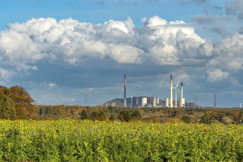 Symboldild with clouds Cumulus calvus for wind energy at the top, Uniper power plant with fossil