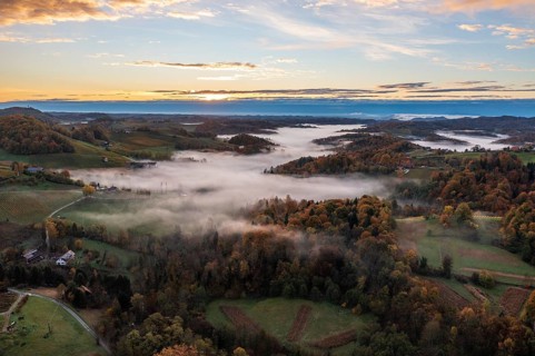 Aerial view, sunrise, typical landscape in autumn with vineyards, South Styrian hills, South