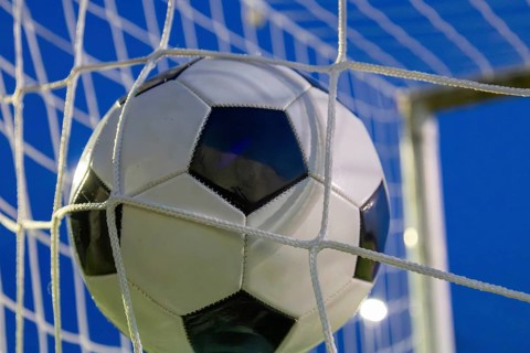 Soccer symbol: close-up of a soccer ball under floodlights