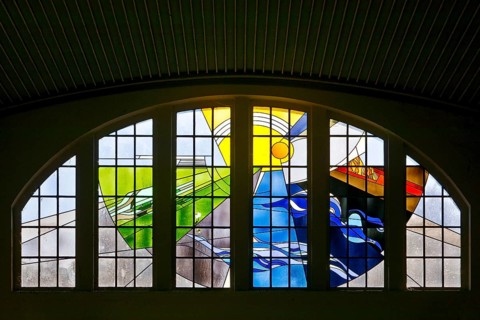 Lead glazing of the windows above the main entrance with the title Four Elements by Horst