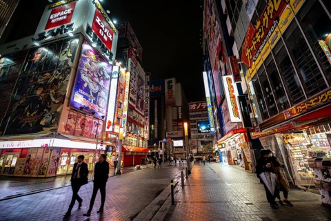 Street with illuminated shops and neon signs at night in Akihabara, Electric City, Tokyo, Japan