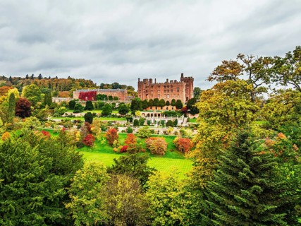 Autumn colours over Powis Castle and Garden from drone, Welshpool, Powys, Wales, England, United
