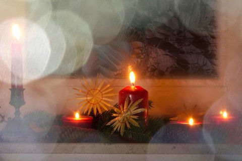 Christmassy decorated iced window, candle light, straw stars, Germany