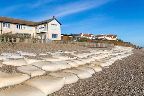 For Sale estate agent signs outside houses at risk of coastal erosion, Thorpeness, Suffolk, North