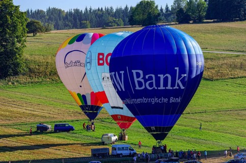 Hot air balloons are being prepared for takeoff as part of an air show at the Fliegerbergfest of