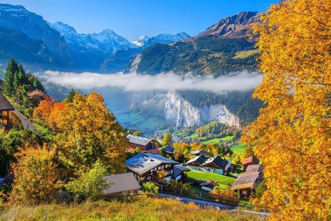 View from the village of the Lauterbrunnen Valley with Staubbach waterfall in autumn with morning