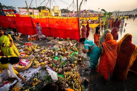 Hindu devotees gather on the banks of the Brahmaputra River to offer prayers to the Sun God on the