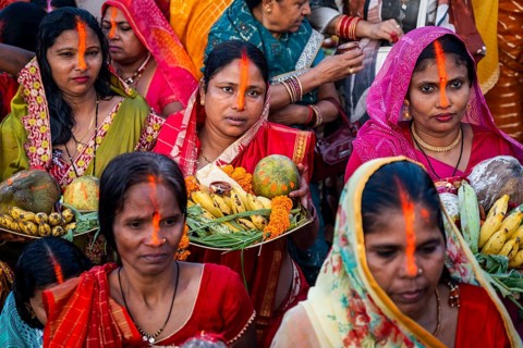 Hindu devotees offer prayers to the Sun God on the bank of Brahmaputra river on the occasion of