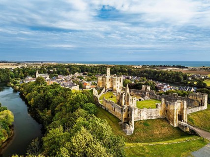 Warkworth Castle over River Coquet from a drone, Warkworth, Northumberland, England, United Kingdom