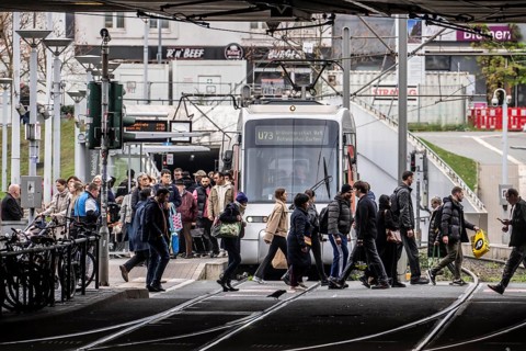 Pedestrians cross the tram tracks, at Düsseldorf-Bilk station, junction of S-Bahn, subway, tram,