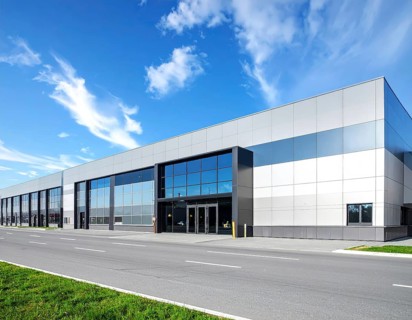 Modern supermarket building exterior against blue sky, Inviting white facade, some clouds, concept