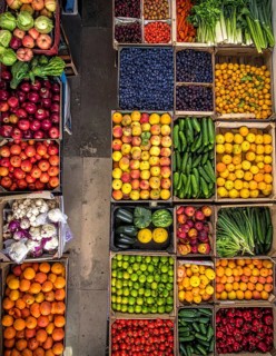 Fresh fruits and vegetables in a market display, aerial view perpendicular top down, healthy eating