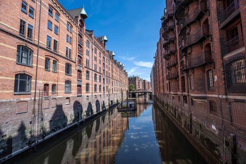 Canal between red brick buildings, warehouses in Hamburg's Speicherstadt, Hamburg, Germany