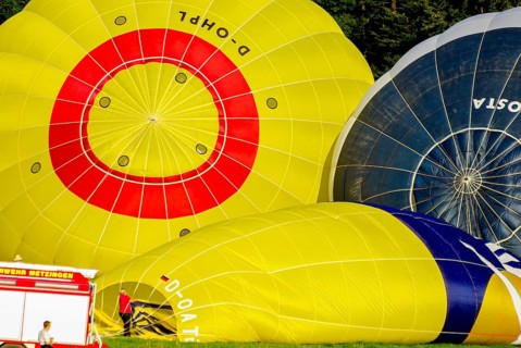 Hot air balloons being prepared for take-off as part of an air show at the Rossfeld in