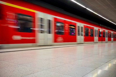 Underground arriving S-Bahn, train, class 420 in traffic red, platform, stop, station city centre,