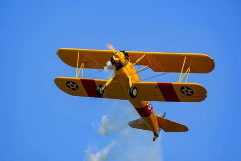 A Boeing-Stearman biplane during a flight demonstration as part of an air show at the Rossfeld in