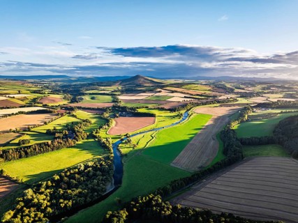 Fields and Farms over River Teviot and Minto Crags from a drone, Roxburghshire, Scottish Borders,